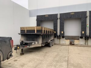 Dumpster trailer at commercial loading dock for debris removal