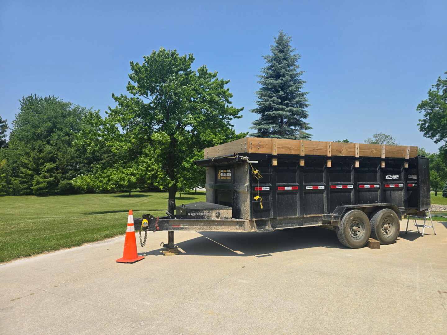dumpster rental in Bruce Township MI driveway safe trailer on residential driveway with open space