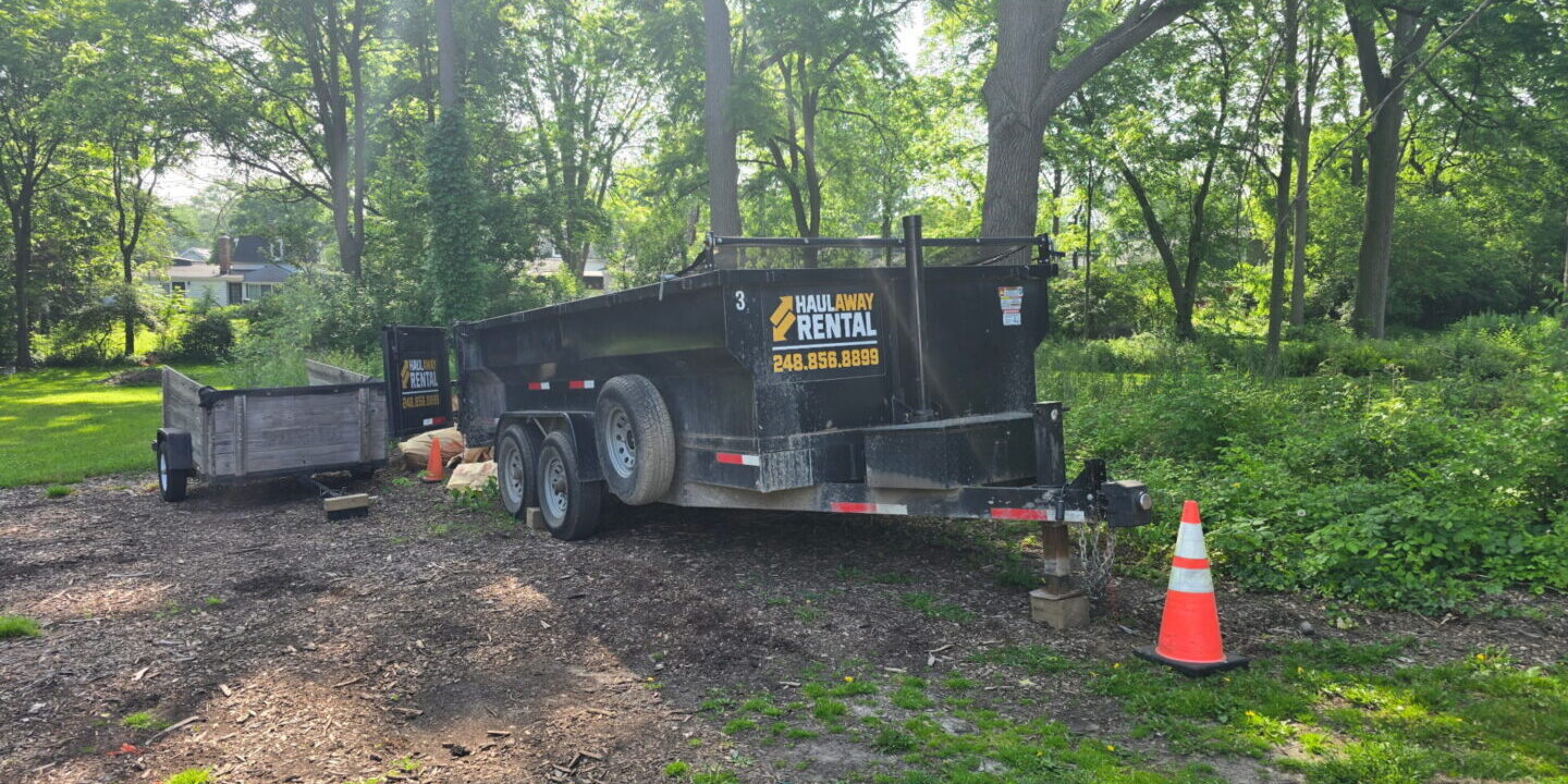 dumpster rental in Romeo MI driveway safe trailer on gravel driveway wooded residential property