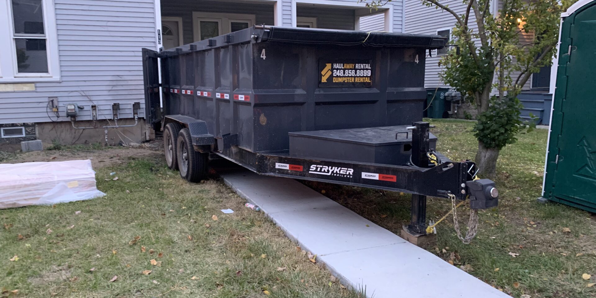 dumpster rental in Royal Oak MI driveway safe trailer in tight residential driveway