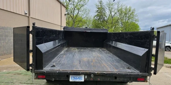 13 yard driveway-safe dumpster trailer parked in driveway