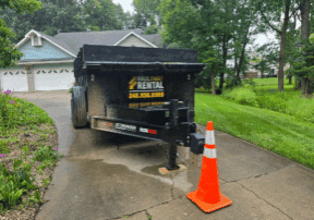 Trailer parked on driveway with cone